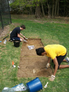 students digging in yard